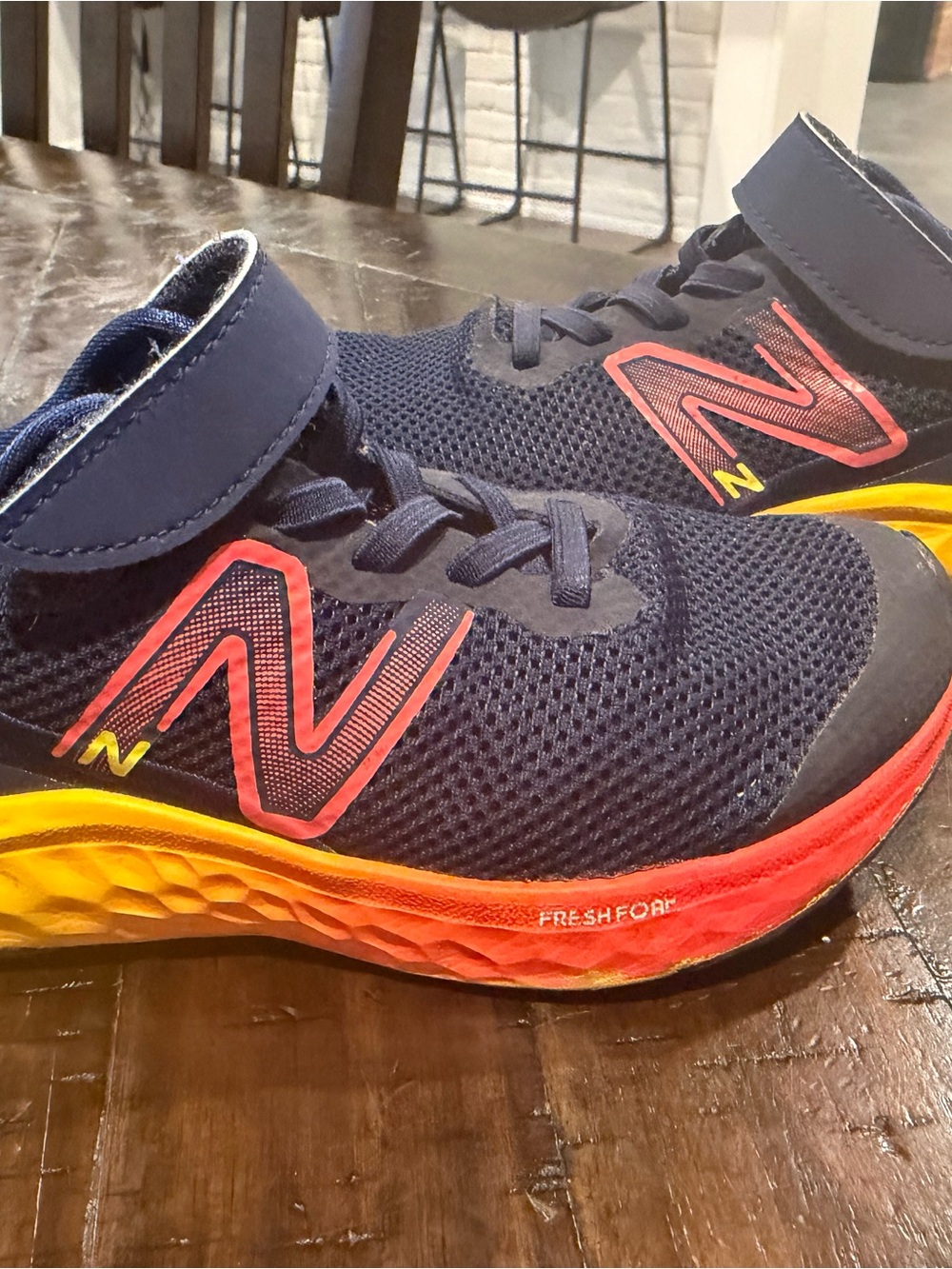 New Balance Kids Navy Blue Athletic Sneakers with orange & Yellow Accents